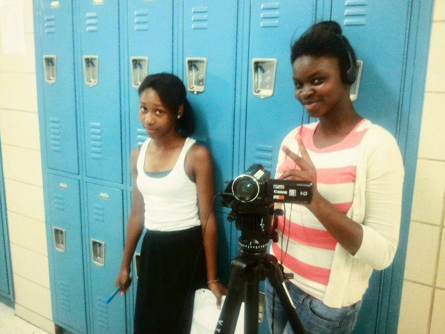 Two middle school girls work on a student camera crew.